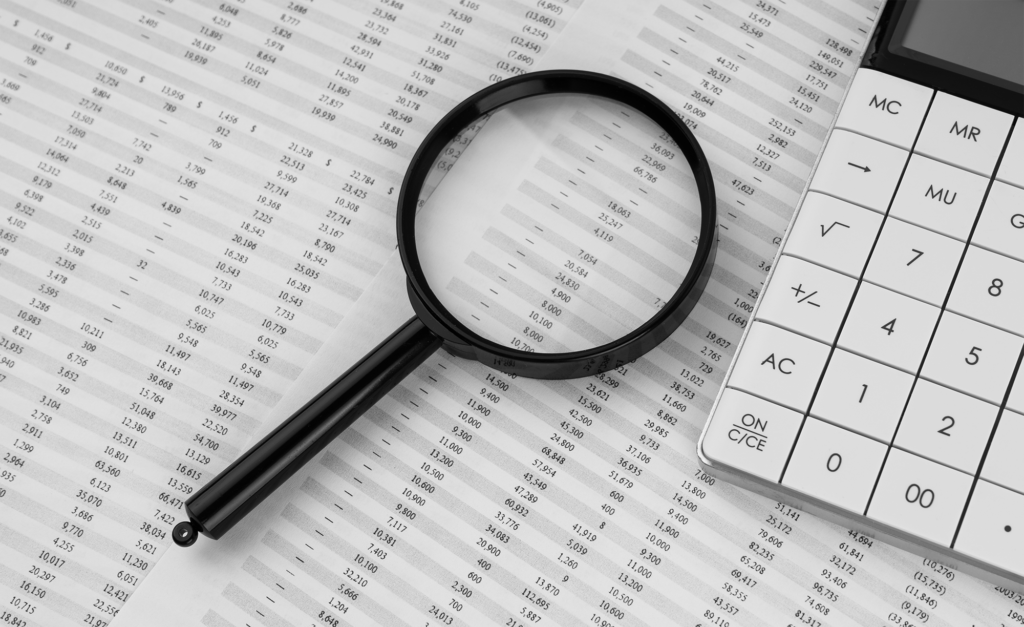 Calculadora e lupa na demonstração financeira Contabilidade financeira e conceito de negócios