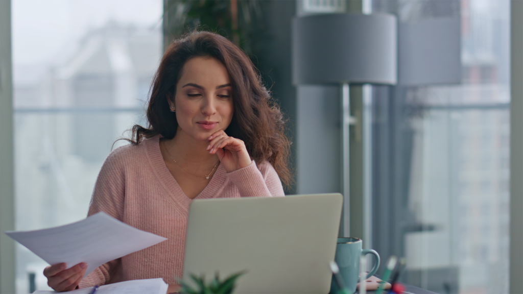 Mulher de negócios confiante falando em videoconferência com laptop em close-up panorâmico do escritório